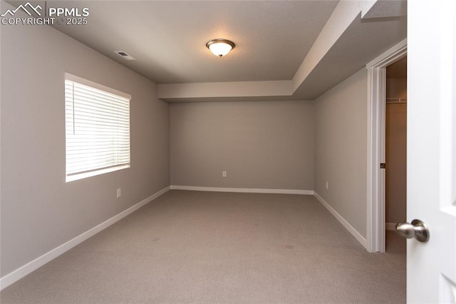 additional living space featuring baseboards, carpet, and visible vents