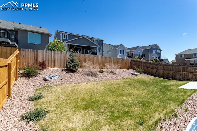 view of yard featuring a residential view and a fenced backyard