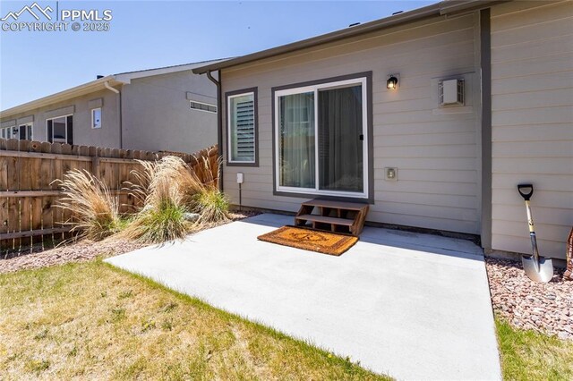 rear view of property featuring fence, a patio, and entry steps