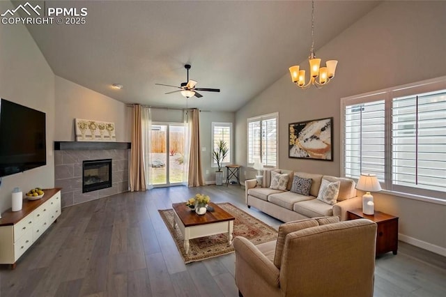 2797 Equine Ct, Colorado Springs, CO 80922 - living area with wood finished floors, ceiling fan with notable chandelier, a fireplace, baseboards, and vaulted ceiling