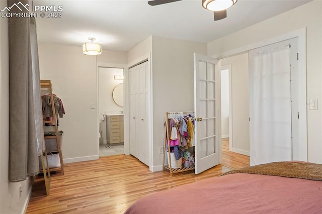 bedroom with ceiling fan, french doors, baseboards, connected bathroom, and light wood-style floors