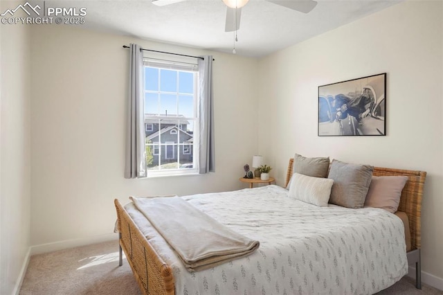 carpeted bedroom featuring baseboards and ceiling fan