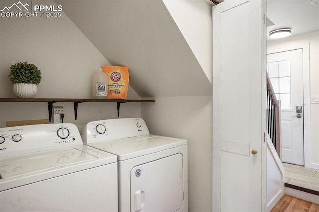 laundry room featuring washer and dryer, laundry area, and light wood-style flooring