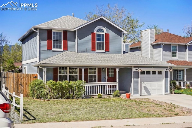 traditional-style house with fence, an attached garage, a front lawn, a porch, and driveway