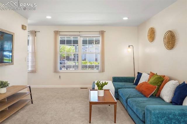 carpeted living area with baseboards and recessed lighting