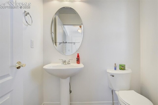 half bath featuring a sink and toilet