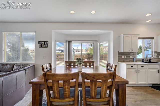 dining area featuring recessed lighting, a wealth of natural light, and light wood-style flooring