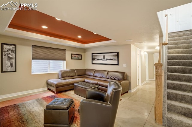 living room featuring stairs, light tile patterned flooring, baseboards, recessed lighting, and a tray ceiling