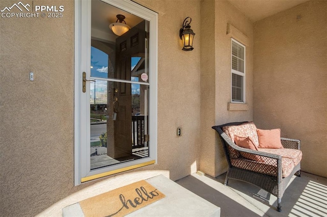 entrance to property with stucco siding