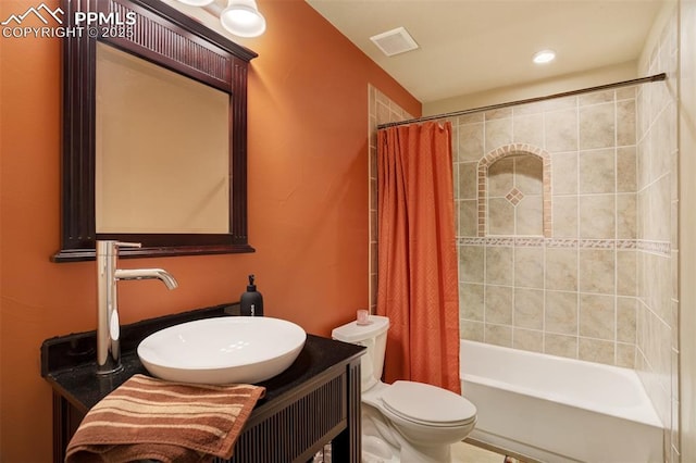bathroom with visible vents, vanity, toilet, shower / tub combo with curtain, and recessed lighting