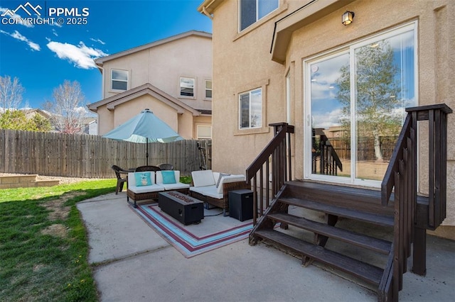 view of patio featuring an outdoor living space with a fire pit, fence, and entry steps