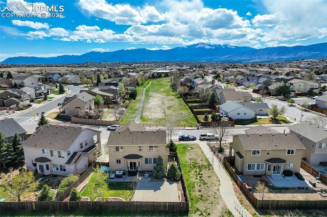 drone / aerial view featuring a residential view and a mountain view