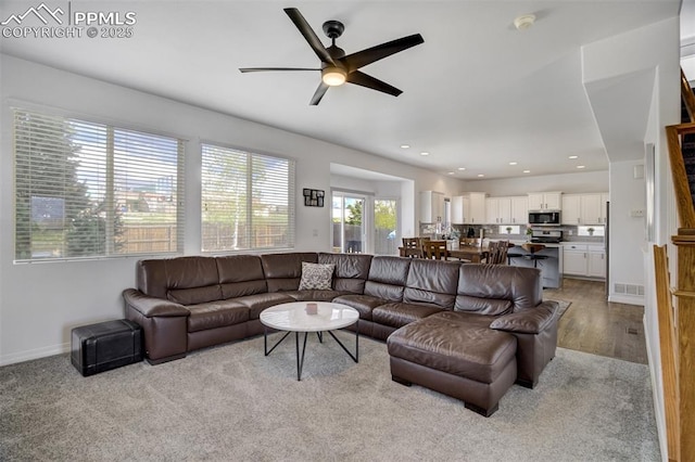 living room featuring visible vents, carpet flooring, baseboards, recessed lighting, and a ceiling fan