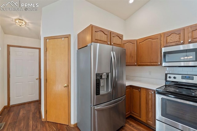6151 Pine Hill Dr, Colorado Springs, CO 80918 - kitchen with light countertops, appliances with stainless steel finishes, brown cabinetry, and dark wood-style flooring