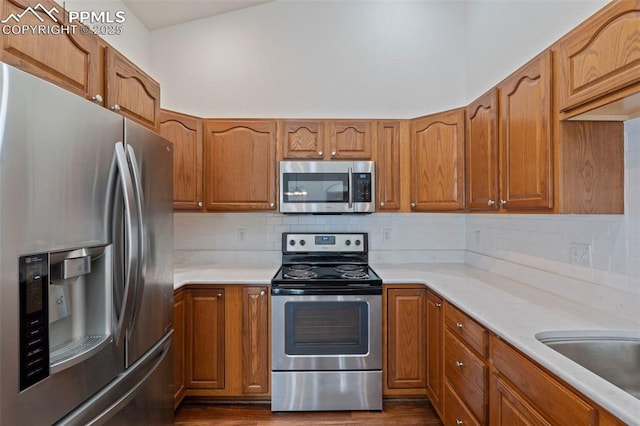 6151 Pine Hill Dr, Colorado Springs, CO 80918 - kitchen featuring light countertops, brown cabinets, and appliances with stainless steel finishes