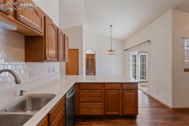 6151 Pine Hill Dr, Colorado Springs, CO 80918 - kitchen featuring tasteful backsplash, stainless steel dishwasher, brown cabinets, a sink, and a peninsula