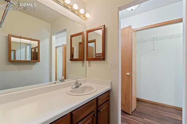 6151 Pine Hill Dr, Colorado Springs, CO 80918 - bathroom with baseboards, wood finished floors, and vanity