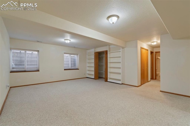 6151 Pine Hill Dr, Colorado Springs, CO 80918 - basement featuring baseboards, a textured ceiling, and light carpet