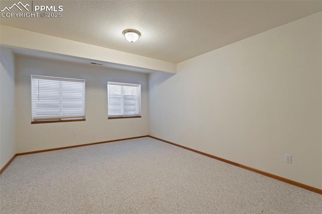 6151 Pine Hill Dr, Colorado Springs, CO 80918 - carpeted empty room featuring baseboards, a textured ceiling, and visible vents
