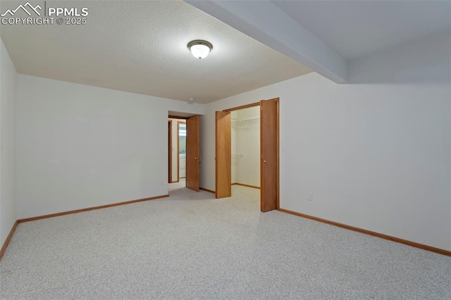 6151 Pine Hill Dr, Colorado Springs, CO 80918 - empty room featuring baseboards, a textured ceiling, and light colored carpet