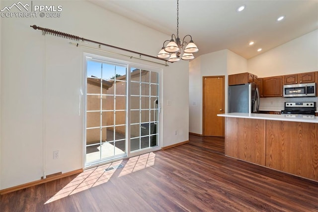 6151 Pine Hill Dr, Colorado Springs, CO 80918 - kitchen featuring appliances with stainless steel finishes, an inviting chandelier, light countertops, brown cabinetry, and dark wood-style floors