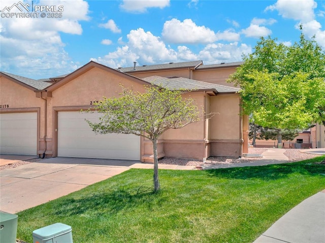 2174 Alpine Shadows Vw, Colorado Springs, CO 80919 - view of front of home featuring stucco siding, driveway, a front yard, and a garage