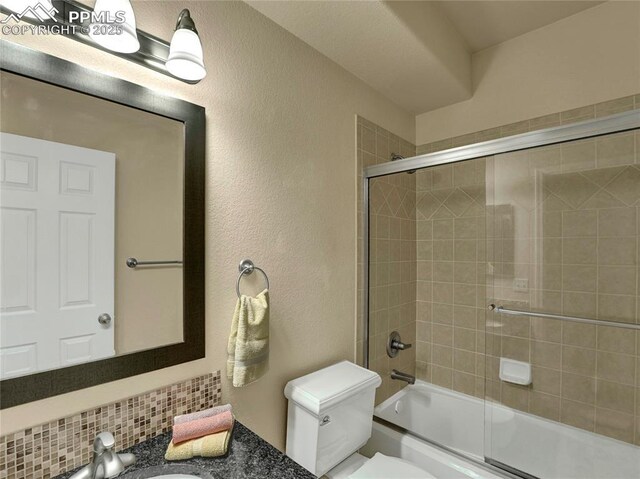 2174 Alpine Shadows Vw, Colorado Springs, CO 80919 - bathroom featuring a textured wall, toilet, enclosed tub / shower combo, and vanity