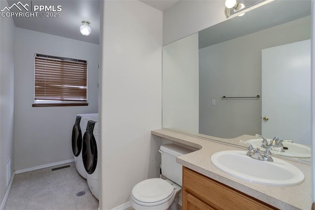 7884 Gladwater Rd, Peyton, CO 80831 - bathroom with baseboards, vanity, tile patterned floors, toilet, and separate washer and dryer