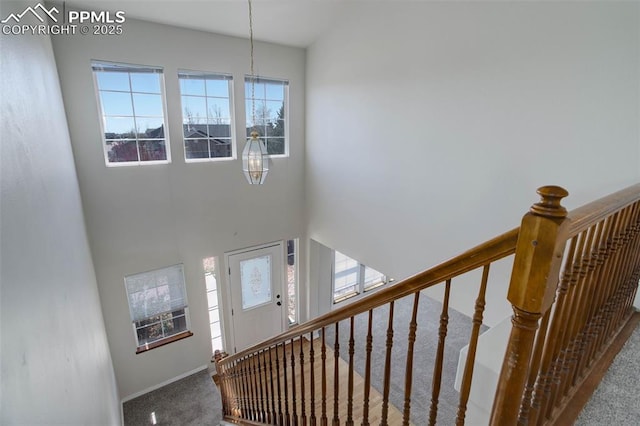 7884 Gladwater Rd, Peyton, CO 80831 - stairway with carpet floors, baseboards, and a towering ceiling