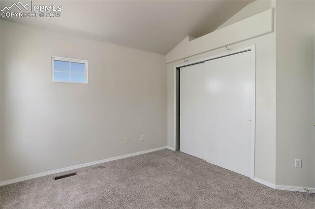 7884 Gladwater Rd, Peyton, CO 80831 - unfurnished bedroom with carpet floors, a closet, visible vents, baseboards, and vaulted ceiling