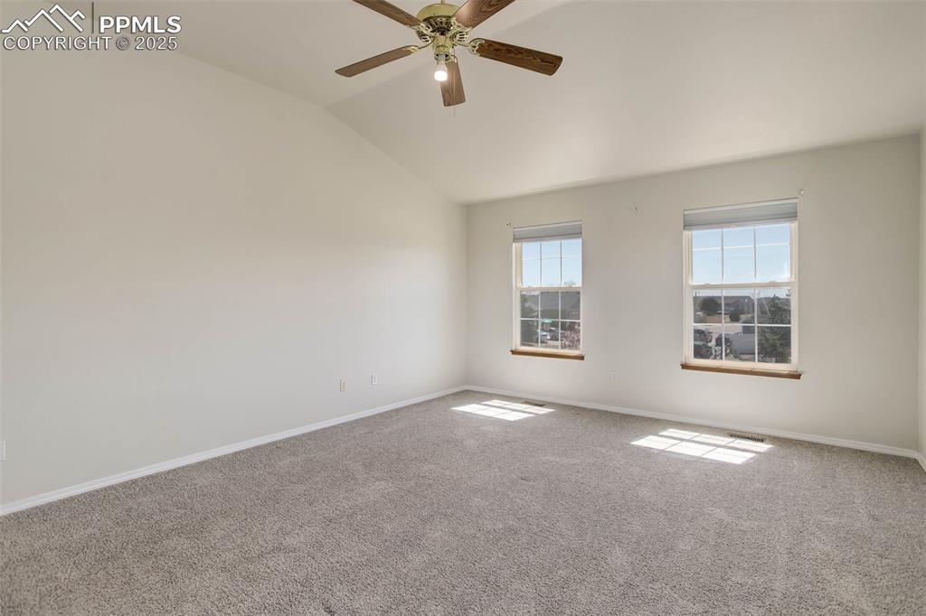 7884 Gladwater Rd, Peyton, CO 80831 - carpeted spare room featuring ceiling fan, vaulted ceiling, and baseboards