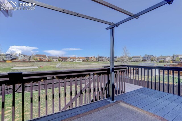 7884 Gladwater Rd, Peyton, CO 80831 - wooden deck with a lawn, fence, and a residential view