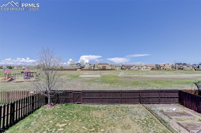 7884 Gladwater Rd, Peyton, CO 80831 - view of yard with a residential view, a garden, and a fenced backyard