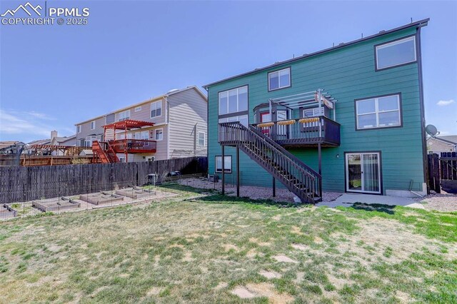 7884 Gladwater Rd, Peyton, CO 80831 - rear view of property featuring a wooden deck, a fenced backyard, a vegetable garden, stairs, and a yard