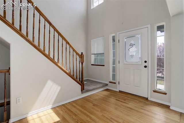7884 Gladwater Rd, Peyton, CO 80831 - entrance foyer with stairs, wood finished floors, and a wealth of natural light