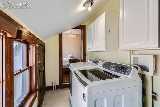 laundry area with washer and dryer, light tile patterned flooring, and cabinet space