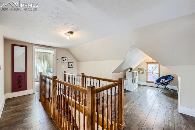 bonus room with baseboards, dark wood-style flooring, and vaulted ceiling