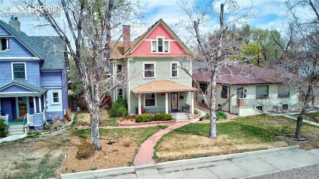 victorian-style house with a porch and a chimney