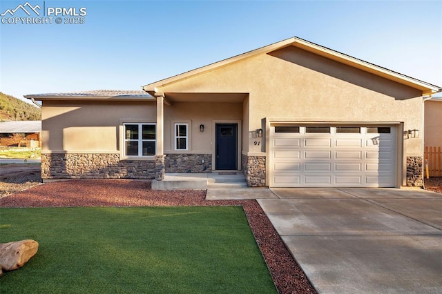 view of front facade featuring stone siding, stucco siding, and an attached garage
