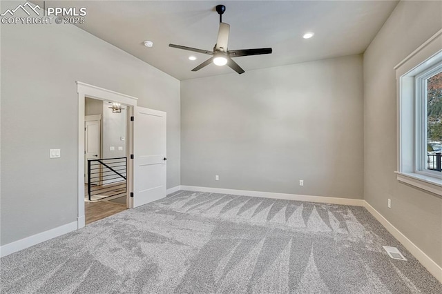 unfurnished bedroom featuring carpet flooring, baseboards, a ceiling fan, and visible vents