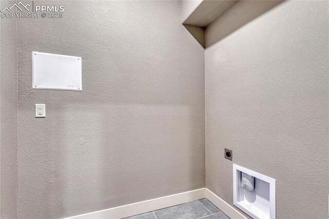 laundry area with laundry area, tile patterned flooring, baseboards, and electric dryer hookup