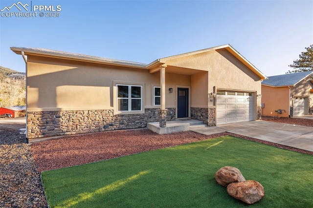 view of front of property with stone siding, stucco siding, and a garage