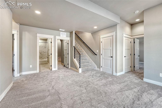 basement featuring carpet, visible vents, recessed lighting, stairway, and baseboards