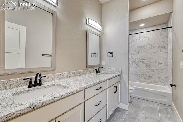 full bath featuring toilet, baseboards, double vanity, and a sink