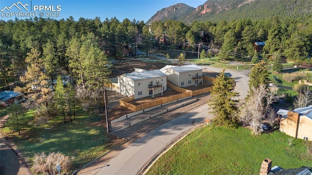 aerial view featuring a mountain view and a forest view