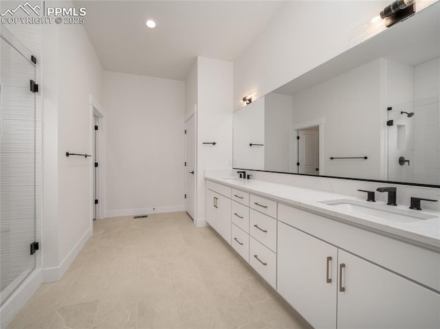 3188 Virga Loop, Colorado Springs, CO 80904 - full bath featuring a sink, double vanity, a shower stall, and recessed lighting