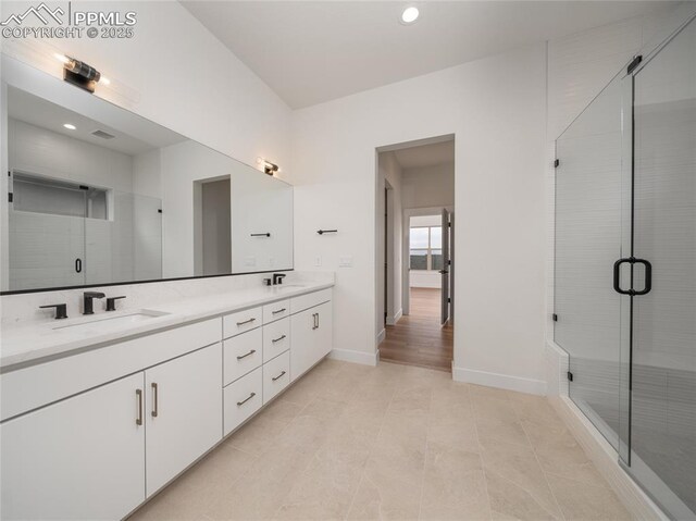 3188 Virga Loop, Colorado Springs, CO 80904 - full bathroom featuring double vanity, baseboards, a shower stall, and a sink