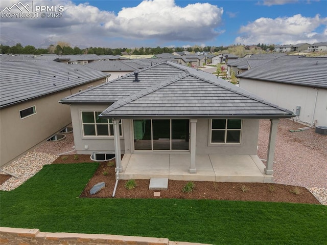 3188 Virga Loop, Colorado Springs, CO 80904 - back of house with a yard, a patio, stucco siding, and a residential view