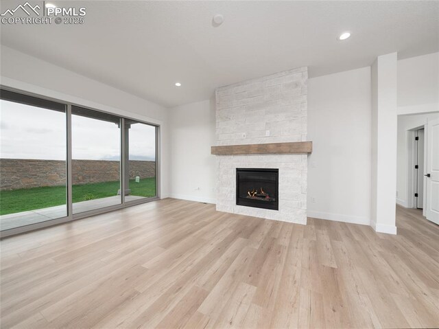 3188 Virga Loop, Colorado Springs, CO 80904 - unfurnished living room featuring baseboards, wood finished floors, a fireplace, and recessed lighting