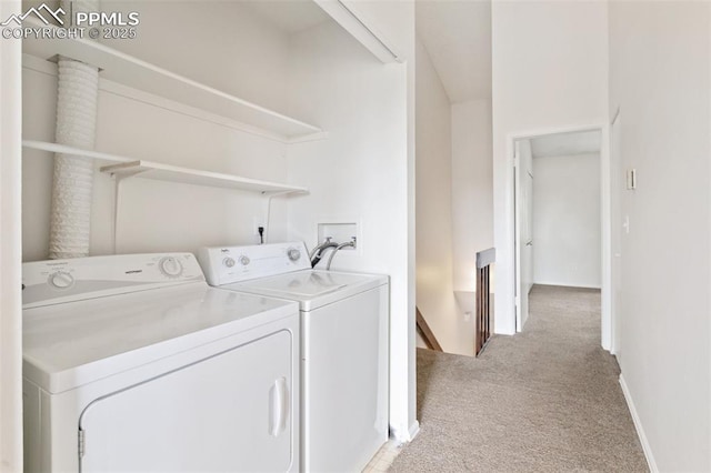 clothes washing area with baseboards, laundry area, light carpet, and independent washer and dryer